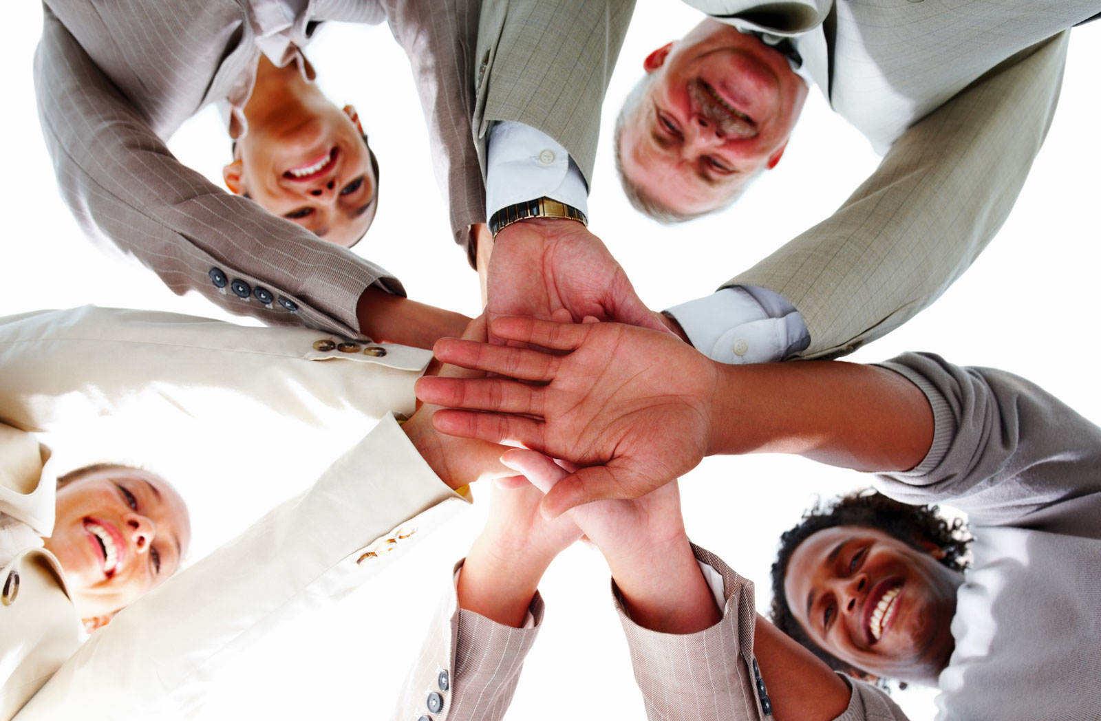 Group of employees with hands in smiling